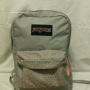 A grey and coral jansport backpack